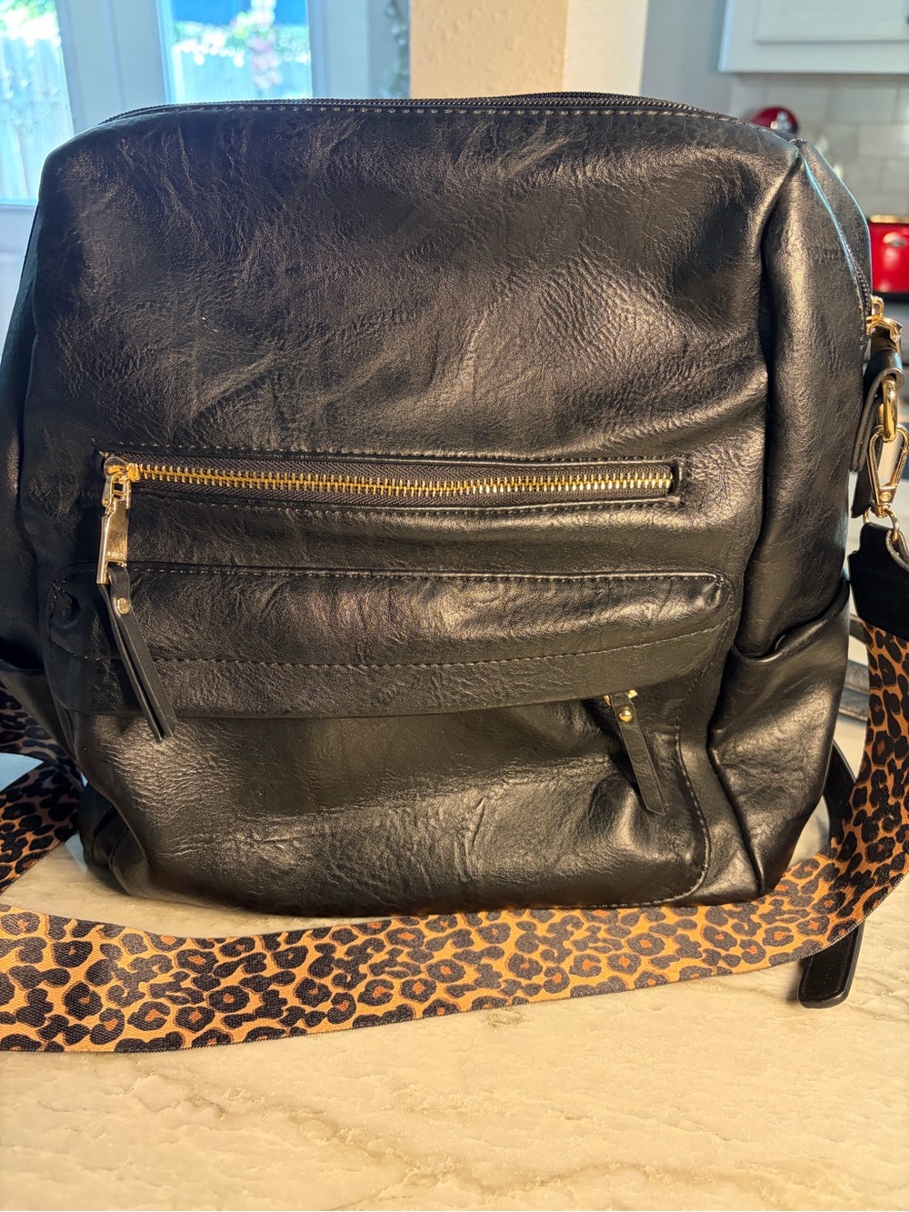 Women’s black backpack with leopard strap Great for a purse or laptop bag.